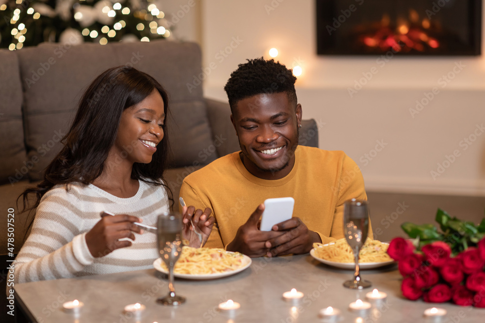 African Couple Using Phone Celebrating Valentine At Home African Couple Using Phone Celebrating Valentine At Home