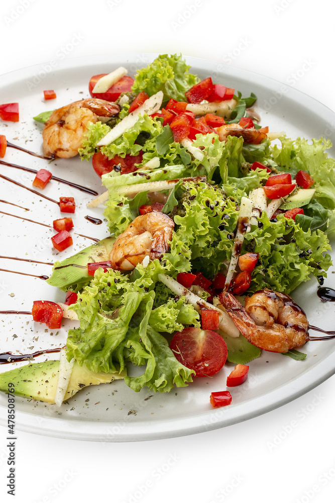 Salad with avocado and tiger prawns, seasoned with pesto sauce. Isolated on a white background. Salad with avocado and tiger prawns, seasoned with pesto sauce. Isolated on a white background.
