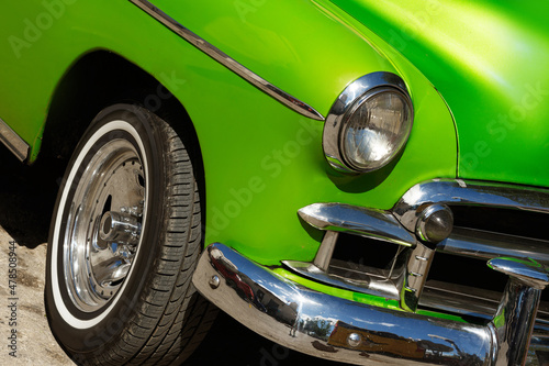 Shiny vintage green car parked on street © blackday