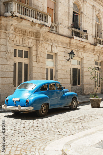 Shiny vintage blue car parked on street © blackday