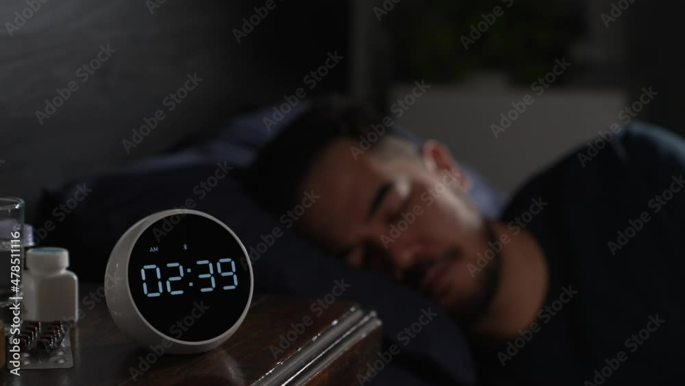 Depressed young Asian man lying in bed cannot sleep from insomnia