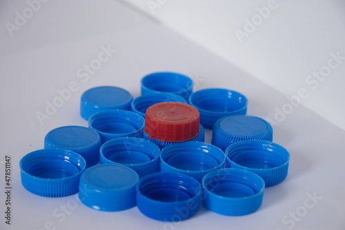 Red plastic cap on the blue plastic caps. 