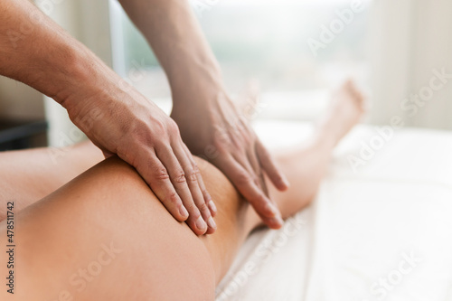Manual therapist working with a client during leg massage