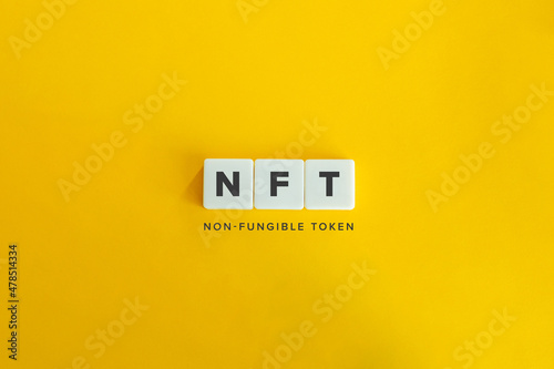 NFT (non-fungible token) banner and concept. Block letters on bright orange background. Minimal aesthetics. photo