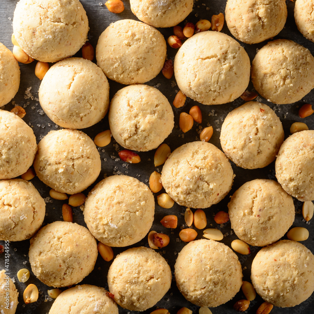 peanut butter cookies, consist of natural peanut butter, flour and sugar, closeup view of baked sweet biscuits with scattered peanuts, food background peanut butter cookies, consist of natural peanut butter, flour and sugar, closeup view of baked sweet biscuits with scattered peanuts, food background
