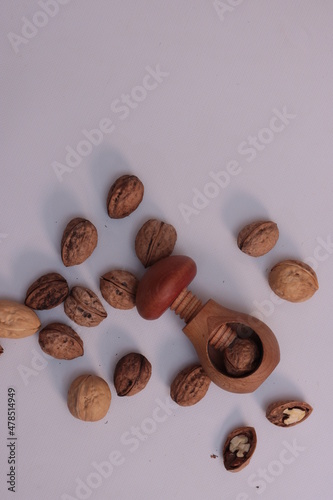Fototapeta Naklejka Na Ścianę i Meble -  Walnuts and wooden nutcracker on white background