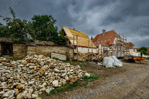 A village farm houses under construction of Viscri in Romania, August 18, 2021	 photo