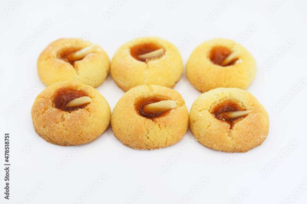 Thumbprint cookies with apricot jam and almonds, white background