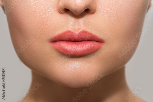 Female lips after permanent makeup lip blushing procedure