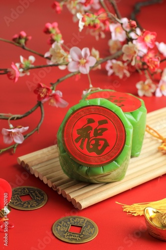 Green Nian Gao Pandan or glutinous rice cake with Good Luck in Chinese Words. Popular as Kue Keranjang or Kue Bakul