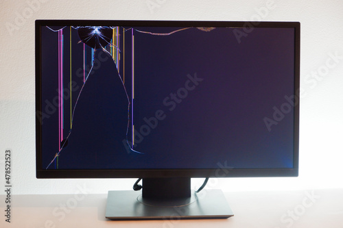 Broken LCD monitor. Cracked LCD Screen. Broken screen of a liquid crystal display, computer monitor. photo