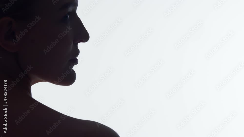 Closeup silhouette nape of woman on white background in studio, turns head to side showing beautiful face with healthy skin. Beautiful female face with well-groomed skin Closeup silhouette nape of woman on white background in studio, turns head to side showing beautiful face with healthy skin. Beautiful female face with well-groomed skin