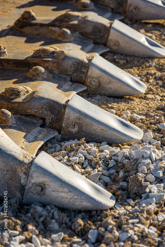 Close-up view of a set of excavator's teeth.