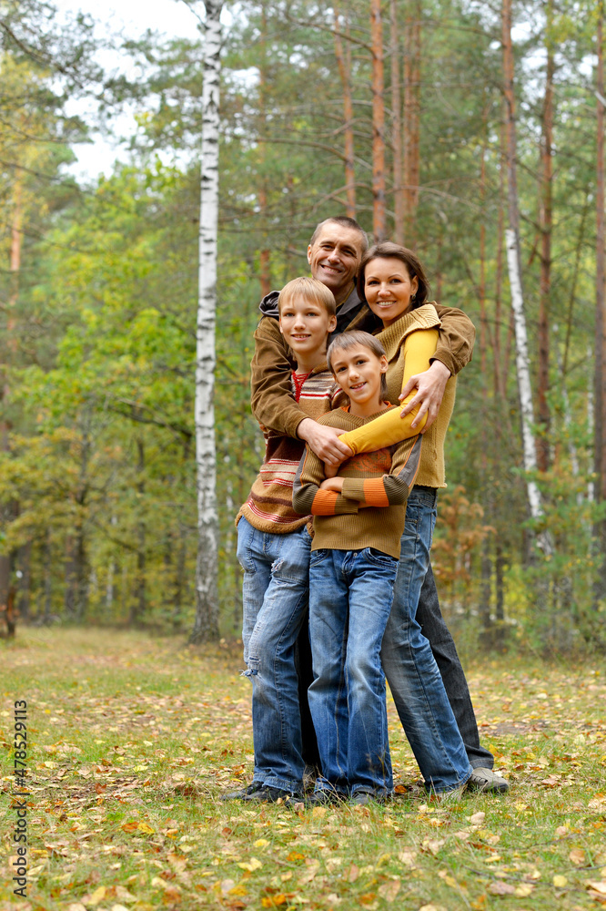 Portrait of family of four in park