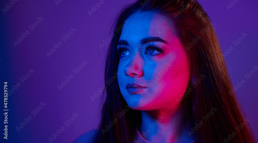 Portrait of fashionable young woman that standing in the studio with neon light Portrait of fashionable young woman that standing in the studio with neon light