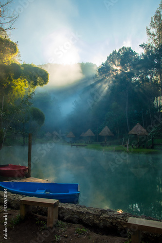 Small fishing boats on small foggy lagoon, Alta Verapaz, Guatemala, near the caves of King Marcos