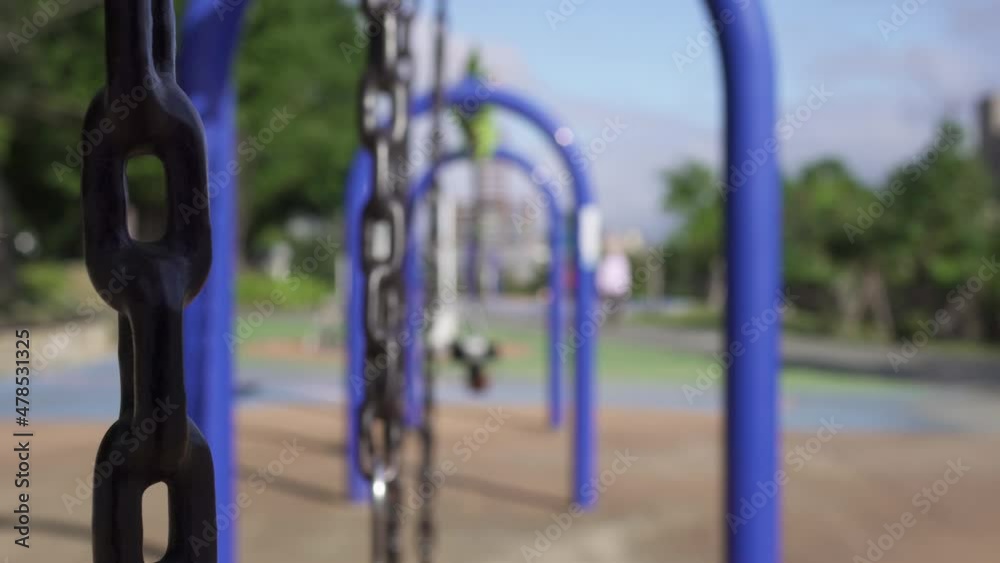 The swing in the park. The weather is fine and nobody playing on the swing. Close up on Chains. The swing in the park. The weather is fine and nobody playing on the swing. Close up on Chains.