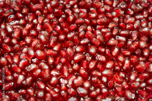 Close-up of fresh and ripe pomegranate seeds. Texture of pomegranate seebs as background.