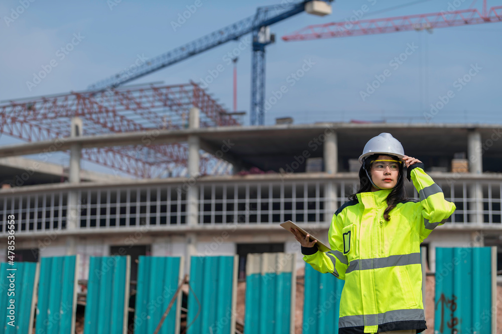 Asian engineer working at site of a large building project,Thailand people,Work overtime at construction site Asian engineer working at site of a large building project,Thailand people,Work overtime at construction site
