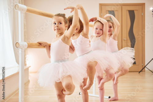 Little ballerinas preparing for performance by practicing dance moves