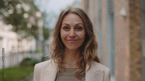 Business lady smiling and looking on camera outdoors