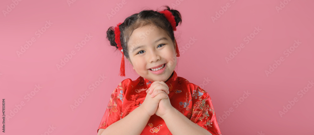 Smiling cute asian little girls in red chinese traditional dress.Happy Chinese new year concept. Smiling cute asian little girls in red chinese traditional dress.Happy Chinese new year concept.