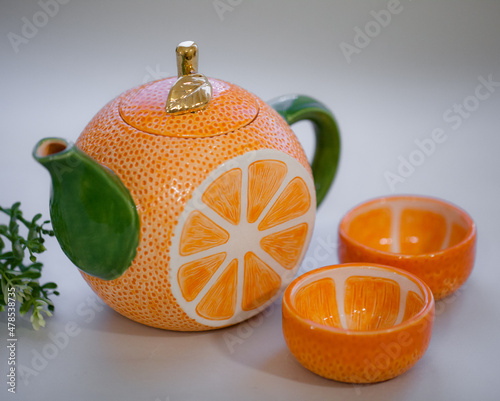 Ceramic teapot handmade orange with a gold leaf