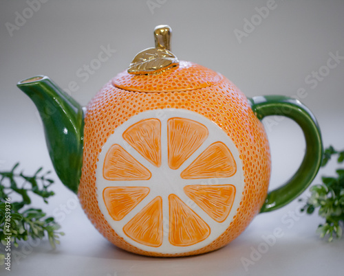 Ceramic teapot handmade orange with a gold leaf