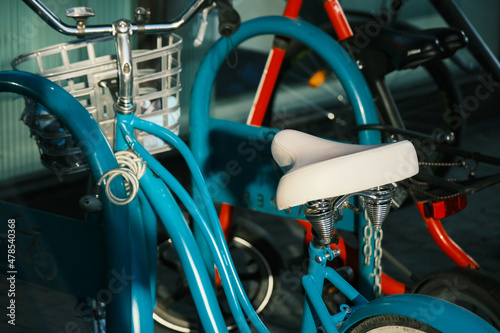 blue retro bicycle on the modern parking row of a mall