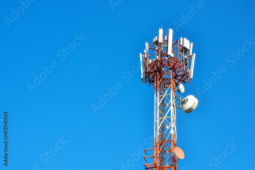 4G and 5G wireless communication antenna transmitter telecommunication tower with separate antenna on sky background.