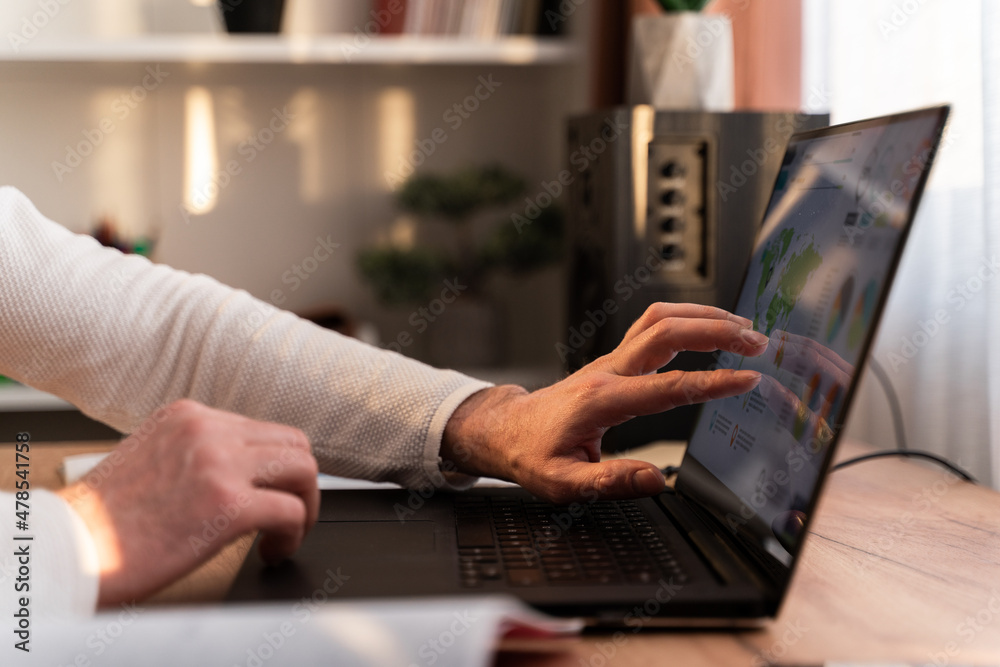 Close up of guy sitting at the table with laptop and working remotely. Stock photo Close up of guy sitting at the table with laptop and working remotely. Stock photo