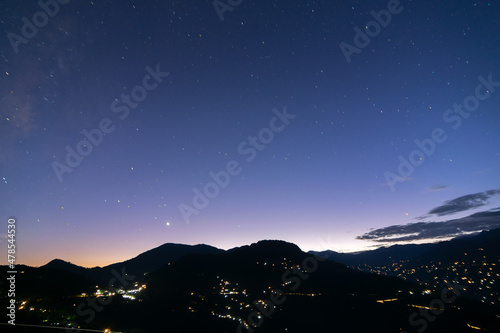 Sky at dusk at Rinchenpong, sikkim , India. With Rinchenpong city at the foreground, the evening dusk sky is lit with remaining light coming from behind Himalayan Mountains, India. photo