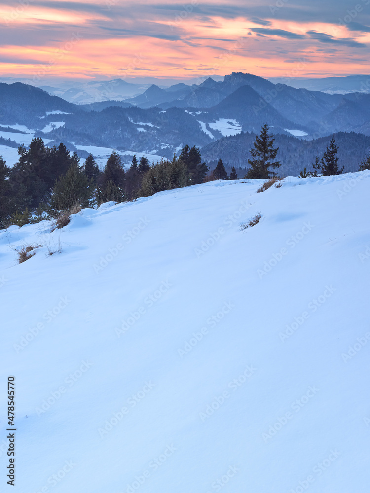 Sunset over the Pieniny Mountains as seen from the top of Wysoki Wierch. Beautiful winter landscape of Polish mountains.