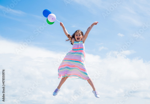 Loving her new style. feel free and joyful. smiling child jump with party balloons. childhood happiness. pretty teenage girl outdoor. kid summer fashion. happy birthday holiday. fashion and beauty © be free