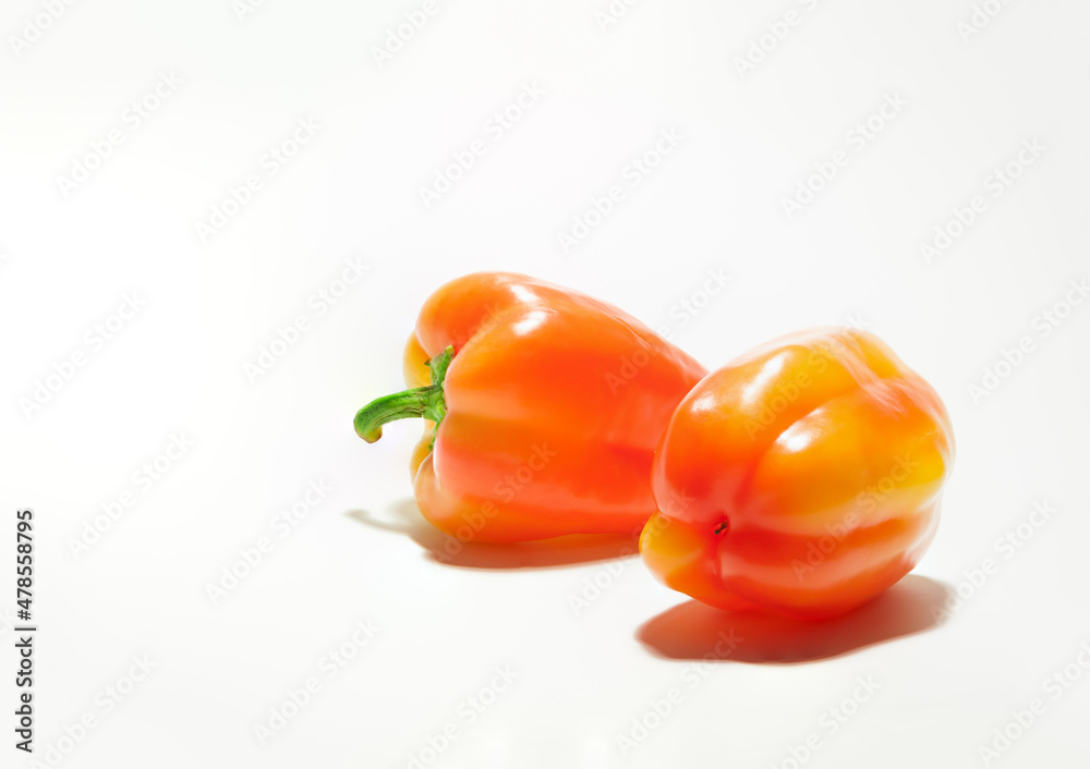 fresh orange bell peppers on the white background with copy space