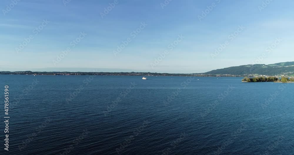 Aerial view of a sailing boat navigating in Lake Constance, Switzerland. Aerial view of a sailing boat navigating in Lake Constance, Switzerland.