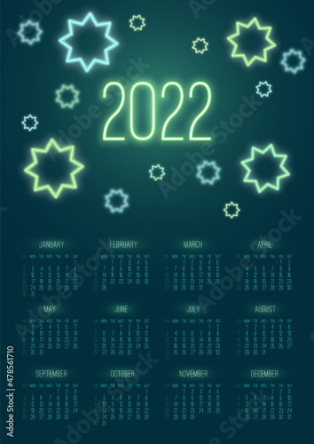 Vector vertical year 2022 calendar with green neon stars on a dark background. A3, A2 poster with luminous geometric shape photo