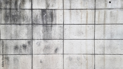 background of weathered concrete block wall. grey grungy and stained outdoor wall background. old grey brick wall.