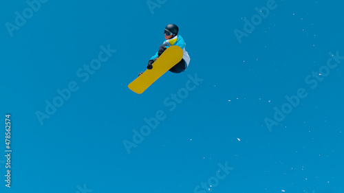 BOTTOM UP: Spectacular shot of a snowboarding pro doing a tumbling grab stunt.