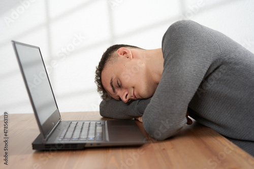 Overworked businessman sleeping at his desk