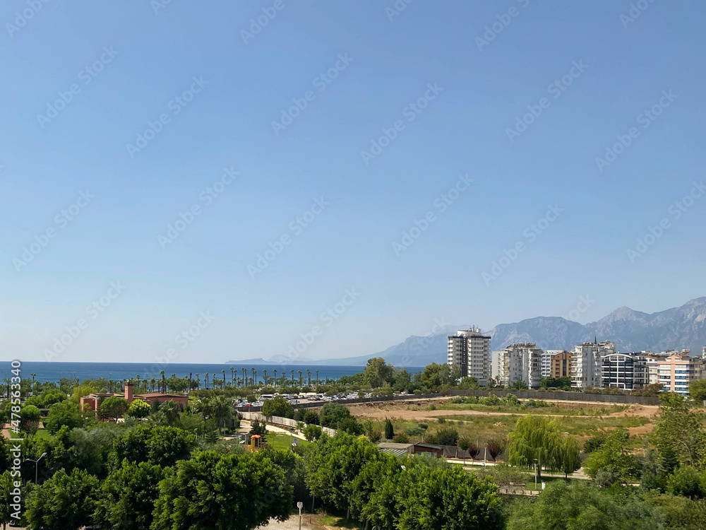 ariel panoramic view of old city and skyscrapers with the sea from the mountains