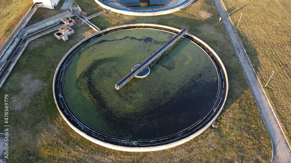 Aerial view of a wastewater treatment plant. During purification, chemicals and microorganisms are removed from the water and the water is returned to river and sea watercourses. Aerial view of a wastewater treatment plant. During purification, chemicals and microorganisms are removed from the water and the water is returned to river and sea watercourses.