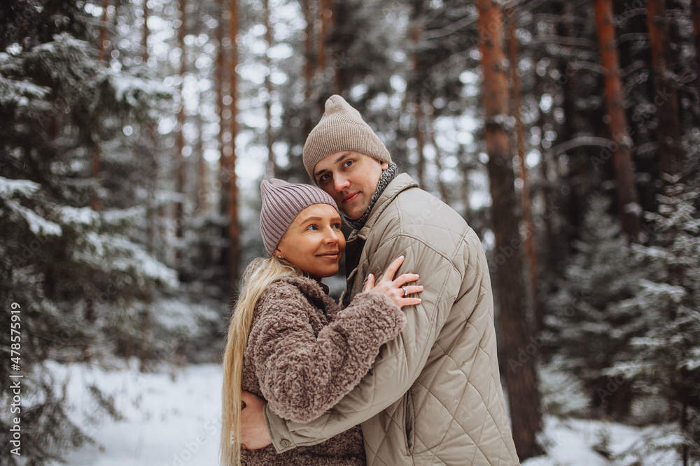 Couple in love on the background of a winter snowy forest