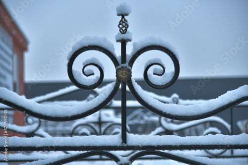 an element of a black metal lattice dusted with snow