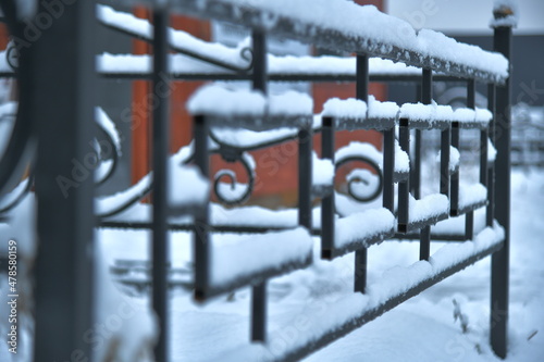 an element of a black metal lattice dusted with snow