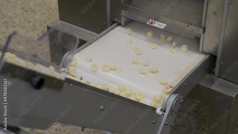4k Production of Italian pasta ocrecchiette by Puglia region in little pasta factory, typical Apulian cuisine. Assembly line in the production of fresh Italian pasta, food industry Italy 4k Production of Italian pasta ocrecchiette by Puglia region in little pasta factory, typical Apulian cuisine. Assembly line in the production of fresh Italian pasta, food industry Italy