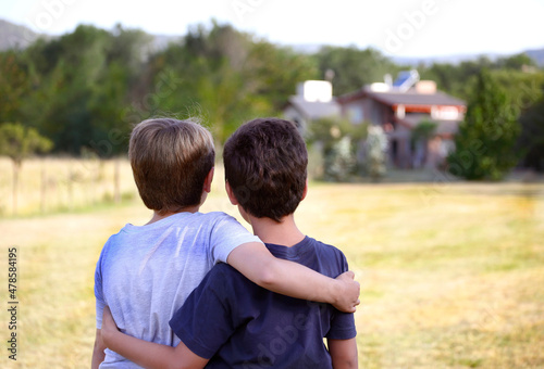 Friends. Family. Brothers. Hug of two children. Friendship and childhood. Gaze at the sky and the future. Happiness. Males Games and friendship. Optimism. Look at the horizon. © Acento Creativo