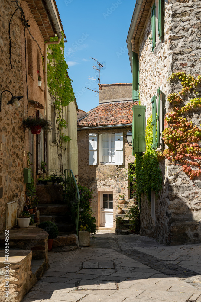 Walking on ancient french village Grimaud, touristic destination with ruines fortress castle on top, Var, Provence, France