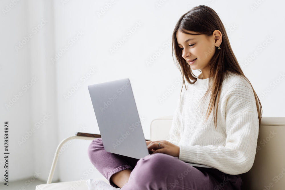 Online education. Little girl watching young teacher give lesson on webcam. Online education. Little girl watching young teacher give lesson on webcam.