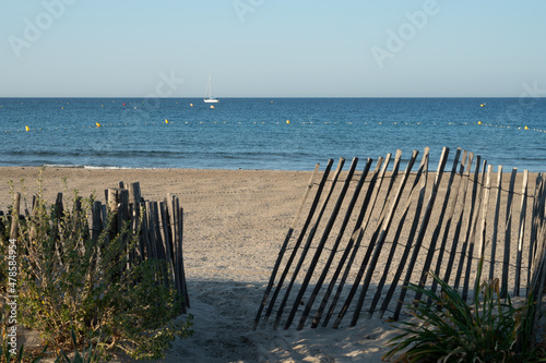 Fototapeta Naklejka Na Ścianę i Meble -  White sandy beach Les Sablettes in La Seyne-sur-mer in morning sunlights